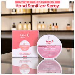 Luna Mist watermelon hand sanitizer spray with packaging on a reflective surface.